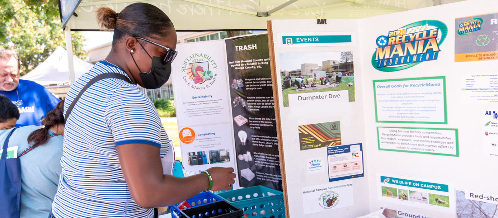 Women looking at the Sustainability board at Recycle Mania