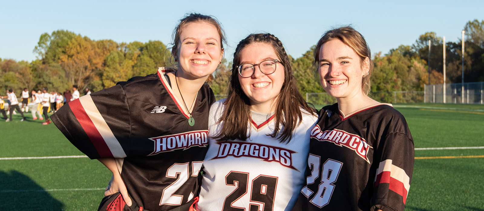 Three HCC students playing flag football