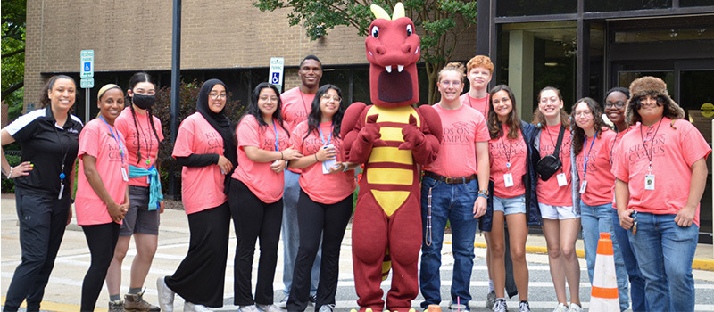 Duncan the Dragon poses with the Kids on Campus Instructional Aides during the summer of 2024.